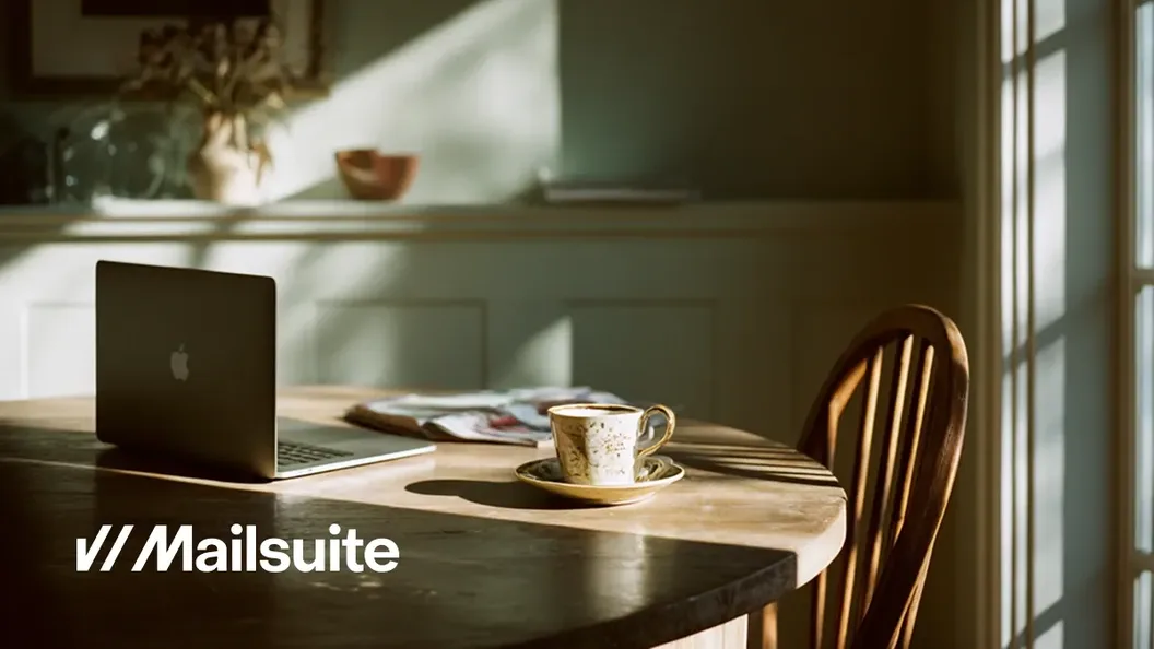 Home office desk with a laptop and the Mailsuite logo, from Mailsuite's customer story